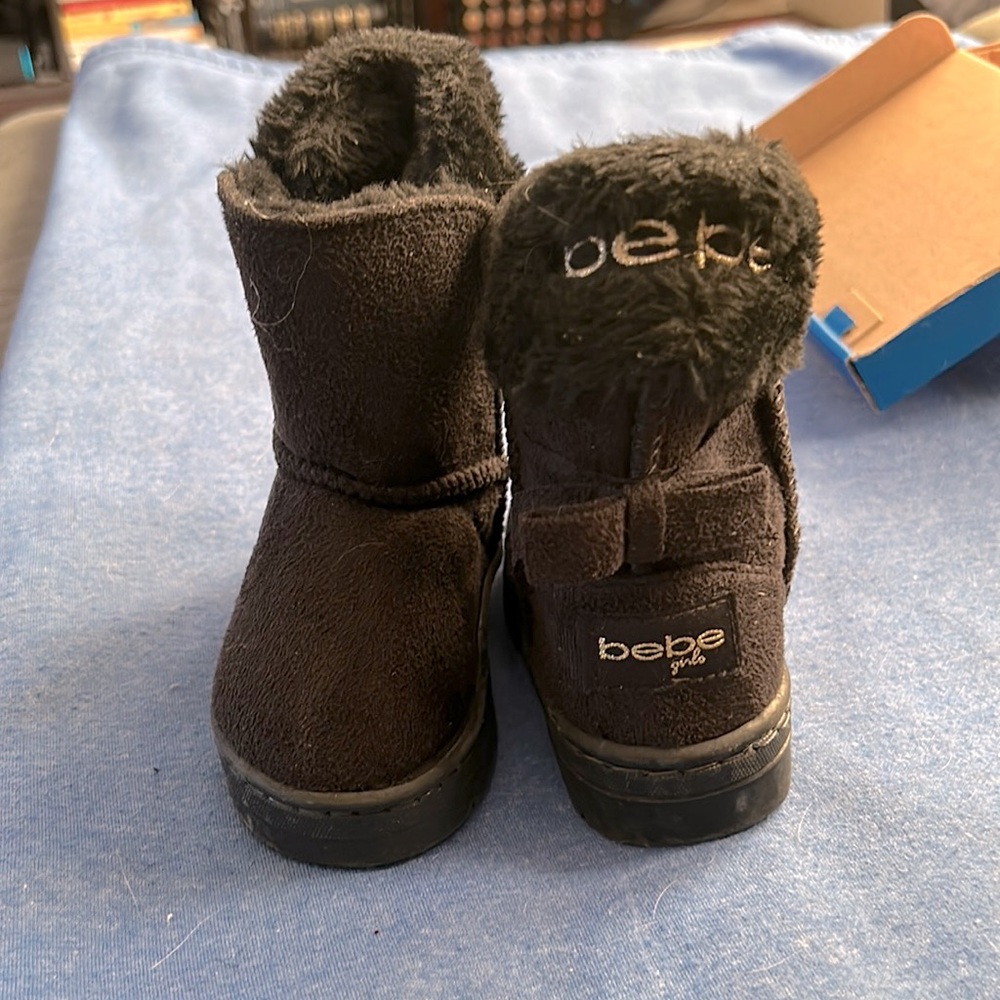 Never worn, Brand new size 7 toddler BeBe boots. Black and fur inside